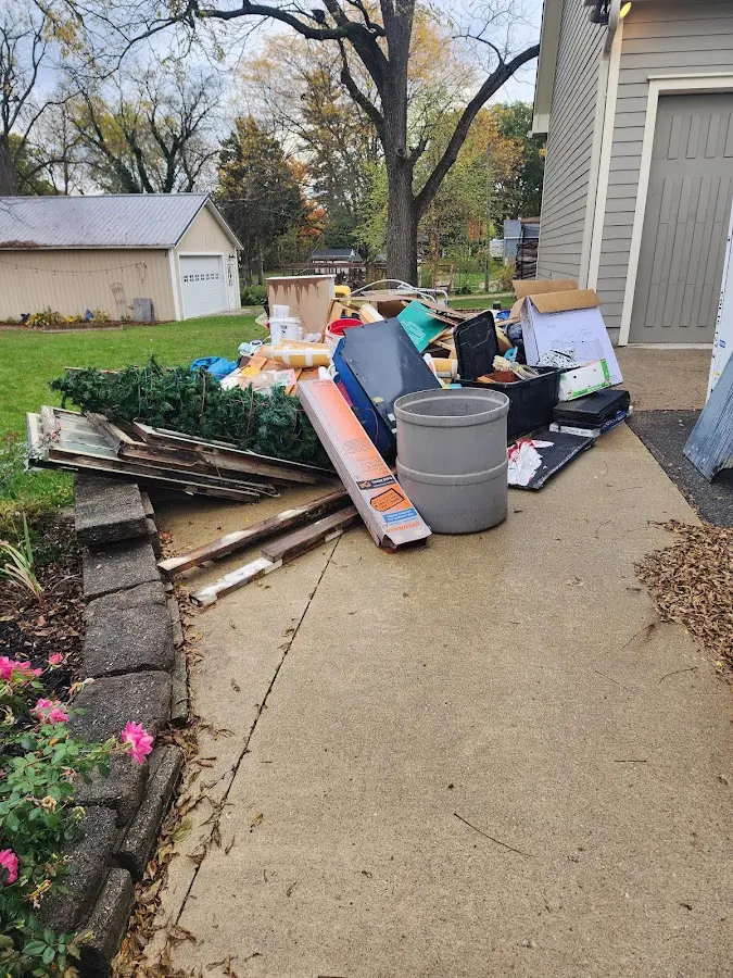 Dumpster being loaded with debris for 3 Yard Dumpster Rental in Napoleon
